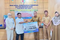 Plt. Kadis Dinsos Didampingi Sekretaris Saat Menyerahkan Secara Simbolis Bantuan PENA Kepada Kelompok Usaha Masyarakat.