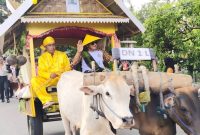 Bupati Touna, Ilham Lawidu Duduk di Gerobak Mengikuti Karnaval Memeriahkan HUT Touna.